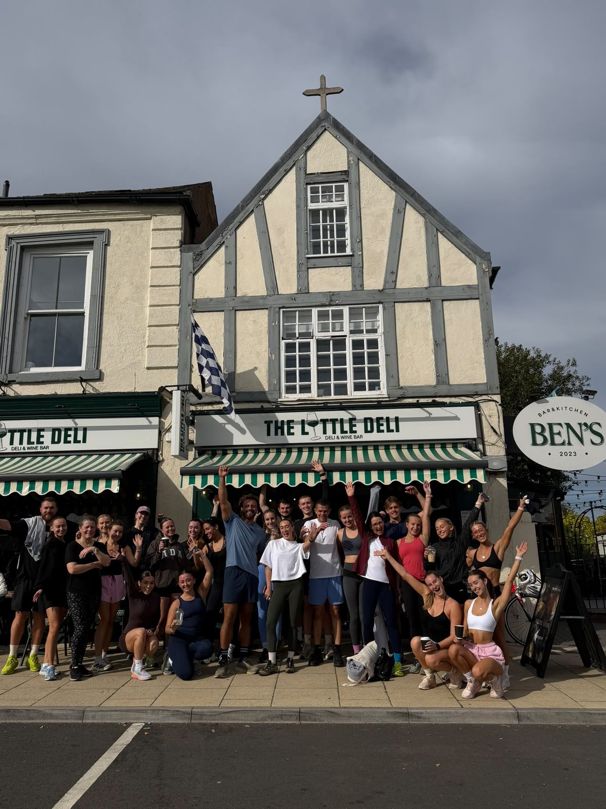Rise and Run: the run club group cheering outside The Little Deli in Bawtry